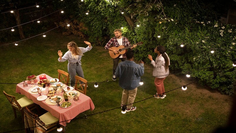 Using Outdoor String Lights To Define Spaces in Your Yard